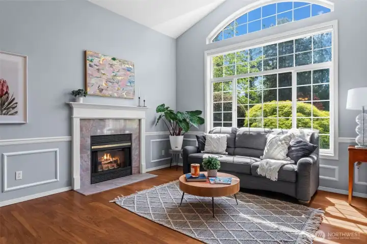Large window, vaulted ceilings and gas fireplace