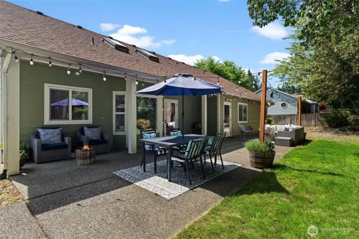 Fully fenced backyard with covered patio area