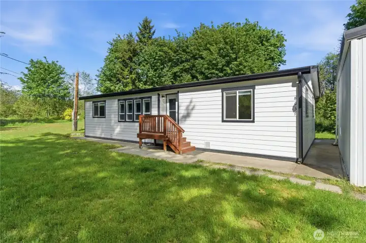 Between the home and the garage is a wide walkway to the back entry and backyard.