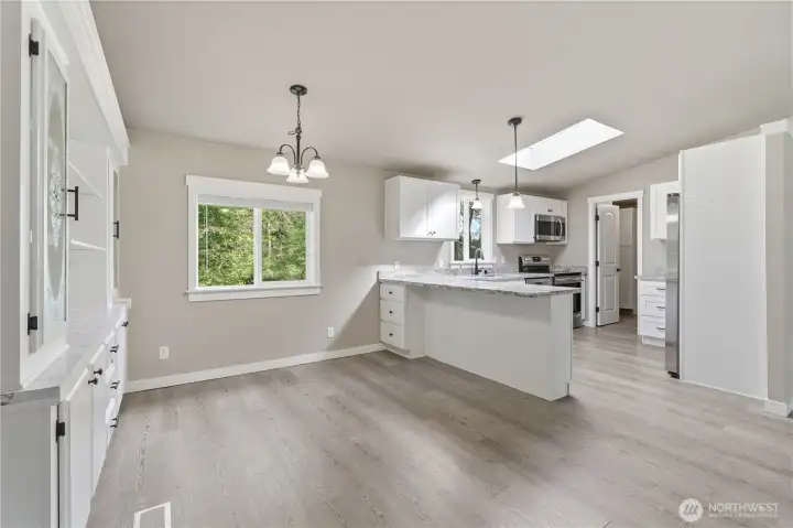 Complete look of the dining & kitchen area- notice you this large sky light and vented slider above the kitchen sink.