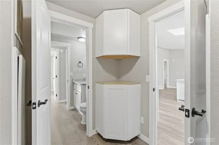 Corner cabinet with more storage on opposite side of washing room