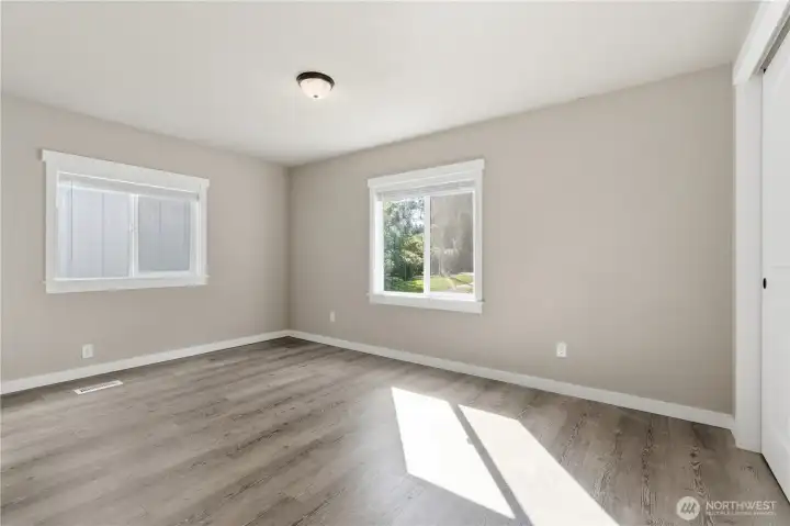 Guest or 1st bedroom, two large windows one overlooking the beauty of the park like front yard the other is adjacent to the walkway between the home and shop.  Large double sliding closet doors.  The bedrooms on this side of the home offer a split bedroom plan.