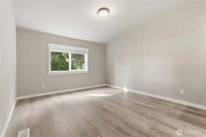 Large primary bedroom is on the front of the home and has an open concept to vanity/wash area and flows to the back left side of the home.  Ample room for large furniture and possible desk area.
