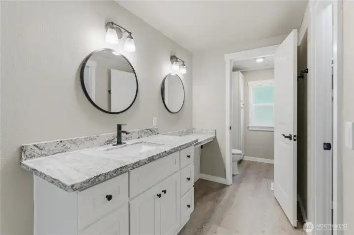 Close up of vanity cabinets and drop vanity area, directly across is a WIC