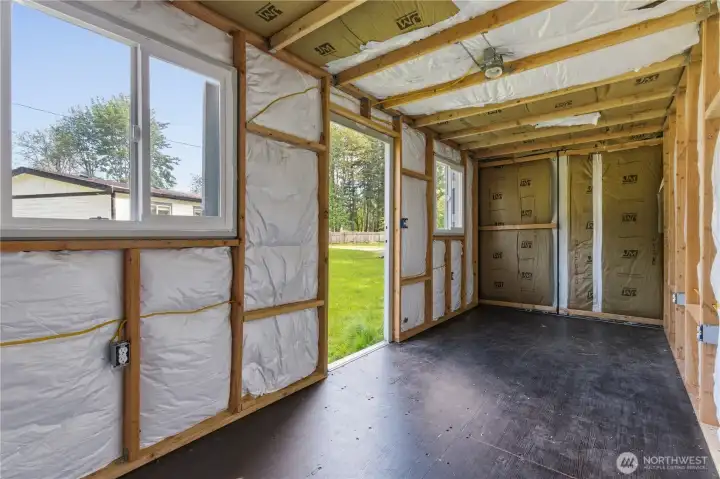 View inside the Conex.  Two vented large windows and back doors (with brown insulation can be opened for convenience.