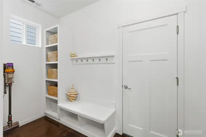 Stay organized with a functional mud room featuring built-in bench seating, shoe storage, coat hooks, and a convenient walk-in pantry just steps away. Stay organized with a functional mud room featuring built-in bench seating, shoe storage, coat hooks, and a convenient walk-in pantry just steps away.