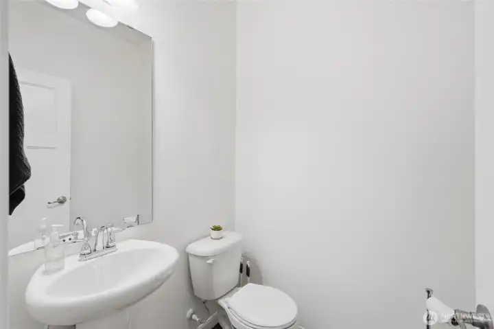 The main-level powder room offers convenience for guests while keeping the upstairs bathrooms private. The main-level powder room offers convenience for guests while keeping the upstairs bathrooms private.