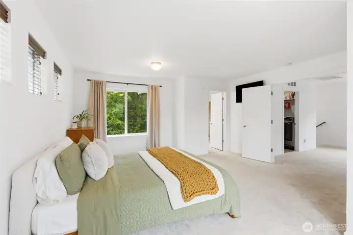 The generously sized primary suite provides a relaxing retreat with tranquil greenbelt views and space for a sitting area. The generously sized primary suite provides a relaxing retreat with tranquil greenbelt views and space for a sitting area.
