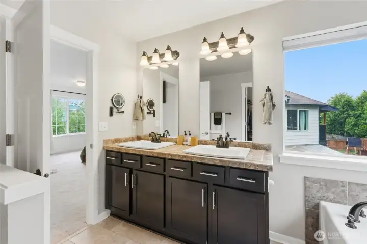 The primary bath offers dual vanities, a soaking tub and separate shower. The primary bath offers dual vanities, a soaking tub and separate shower.