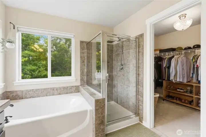 From the luxurious soaking tub, serene views bring the outdoors in. From the luxurious soaking tub, serene views bring the outdoors in.