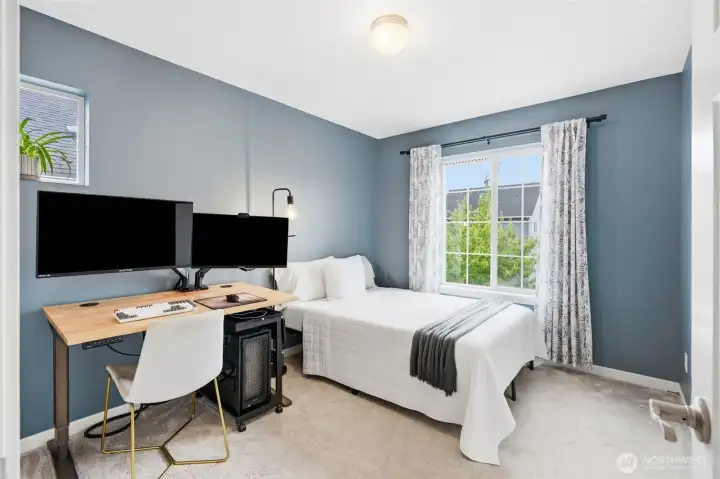 Comfortable and versatile, this secondary bedroom easily accommodates a workspace while maintaining a relaxing retreat. Comfortable and versatile, this secondary bedroom easily accommodates a workspace while maintaining a relaxing retreat.
