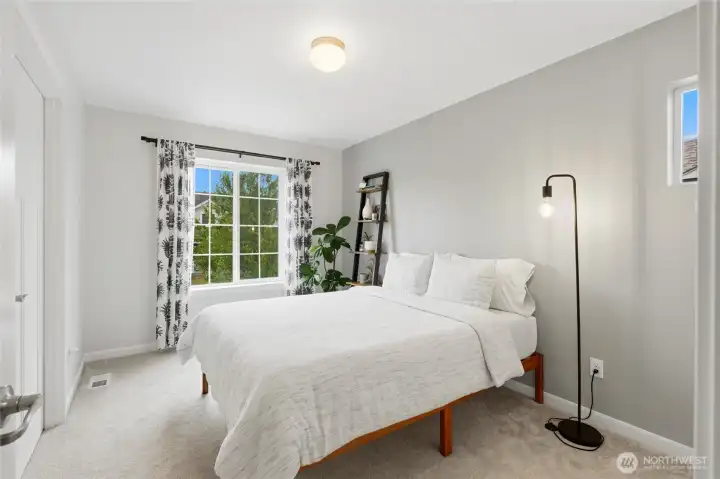 Another generously sized bedroom offers abundant natural light and a warm, welcoming space for family or overnight guests. Another generously sized bedroom offers abundant natural light and a warm, welcoming space for family or overnight guests.