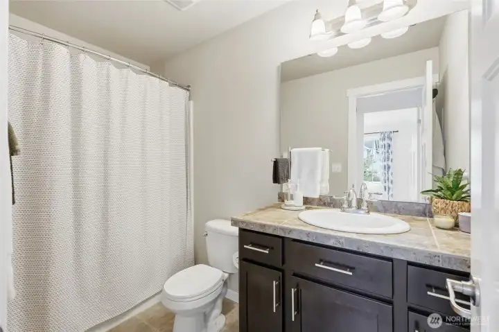 The upstairs full bath features generous counter space and a classic tub/shower combination for everyday comfort. The upstairs full bath features generous counter space and a classic tub/shower combination for everyday comfort.