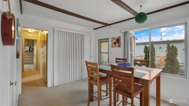 Another view of the dining area, hallway leads to the bedrooms.