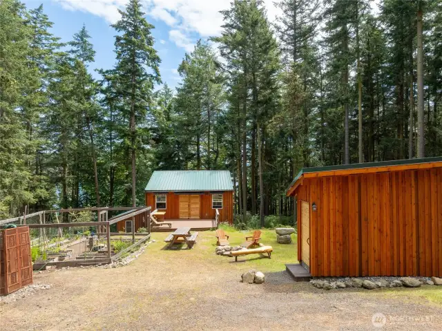 Garden on left, shop center, fire pit, pumphouse right