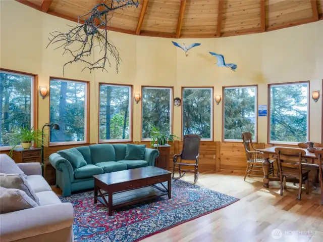 Living room with eucalyptus floors, fir trim on windows, and western red cedar in 17' vaulted ceiling
