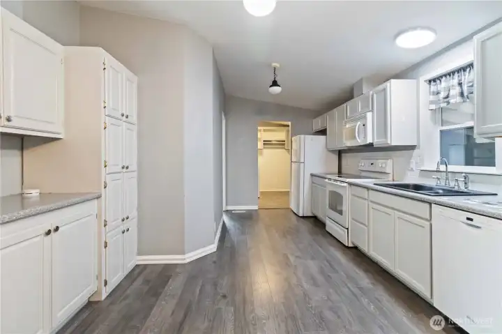 Kitchen looking toward the utility room; main bedroom is at the end of the hall on the left