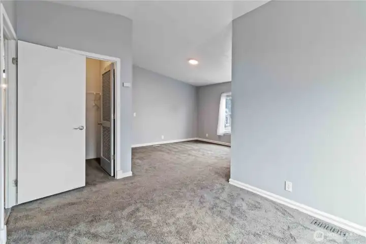 Main bedroom with sitting area, walk-in closet, and ensuite bath