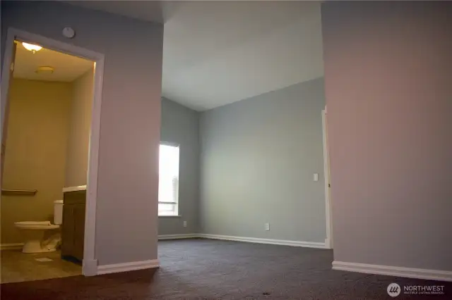 From the main bedroom area, 3/4 bath to the left, looking into a sitting area