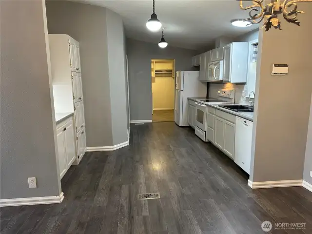 From dining room looking to the kitchen; utility room at the far end; main bedroom is to the left of the utility room