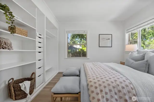 A wall of built in shelving makes use of small spaces while providing a place for your wardrobe.  Whether you keep the space open, add a barn door or curtain, there are many options for this bedroom to make it reflect your style.