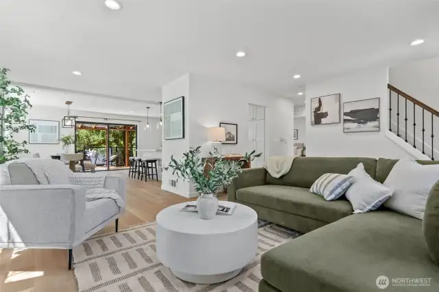The open floor plan, combined with new flooring, creates a seamless flow from room to room.