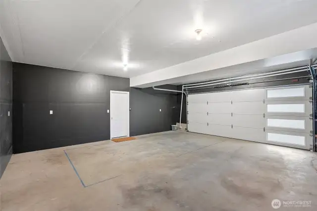 Downstairs garage entry with electric car charging as well as ample storage