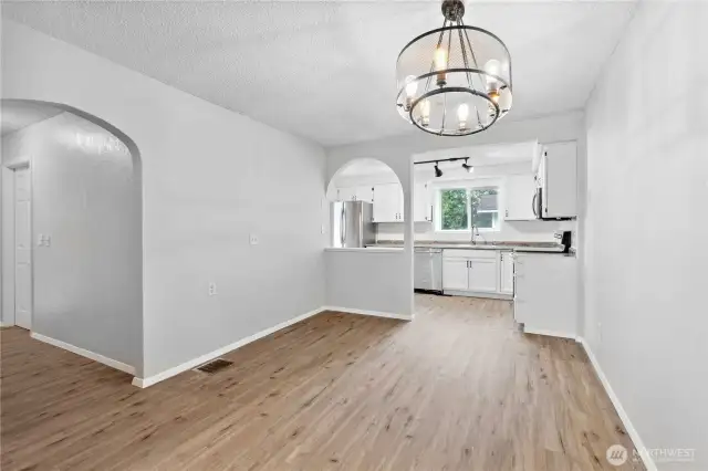 Dining Room looking toward Kitchen. Hall leads to secondary bedrooms and full bath.