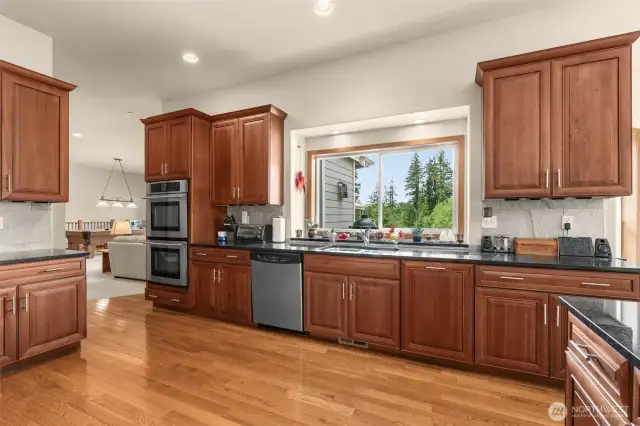 The expansive kitchen is a chef's dream, equipped with top-of-the-line appliances, abundant cabinetry, and a walk-in pantry.