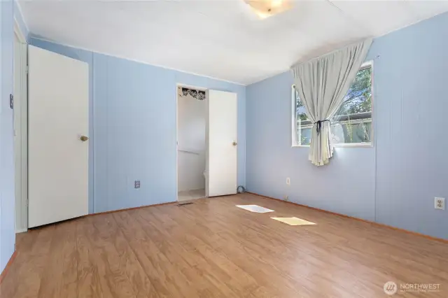 Primary bedroom w/ ensuite half-bath