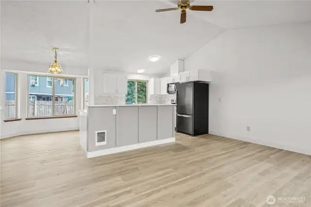Open concept middle floor with living room, kitchen, and dining area