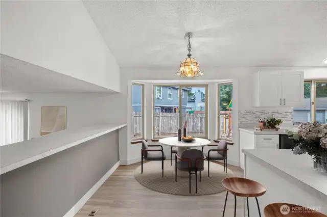 Virtually Staged Dining area and bar overlooking lower level