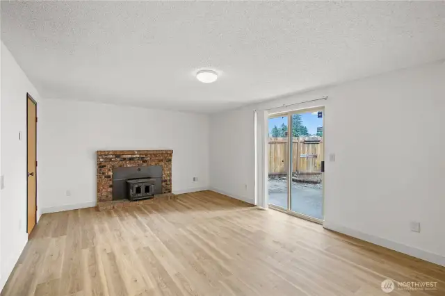 Family room area with new lvp flooring and slider to back patio