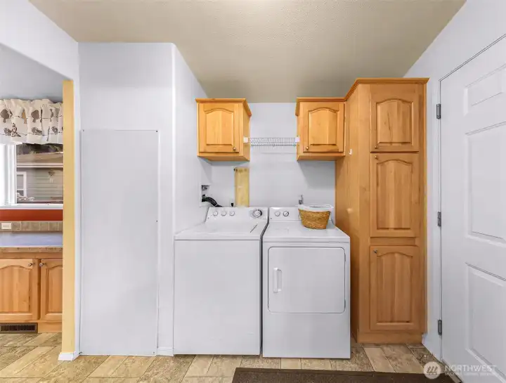 Utility room with Water Heater, washer, dryer, and lots of storage. Great transitional space between garage and kitchen.