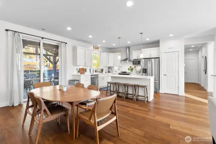 View from living room down hallway, to kitchen, dining and covered deck