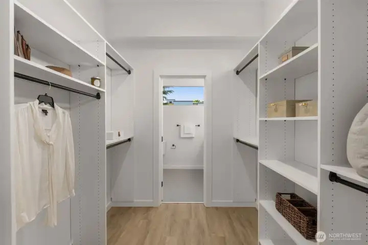 Dressed to impress, this custom walk-in closet delivers luxury-level organization with built-in shelving, open storage, and a view into the spa-like bath. Dressed to impress, this custom walk-in closet delivers luxury-level organization with built-in shelving, open storage, and a view into the spa-like bath.