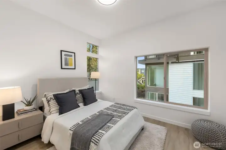 Sunlit and spacious bedroom — Clean lines and natural light make this room perfect for anything, from a guest space to a creative studio. Sunlit and spacious bedroom — Clean lines and natural light make this room perfect for anything, from a guest space to a creative studio.