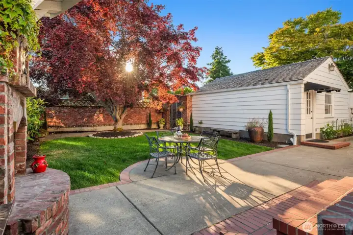 Step into the inviting backyard with old-world charm of a Tuscan villa, where dappled sunlight filters through mature maple trees. Ivy covered brick walls add privacy, making the patio with, BBQ grill,  the custom brick fireplace and pizza oven the perfect setting for sharing fine wine and memorable meals.