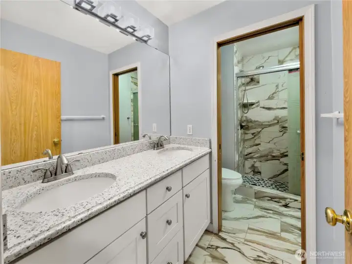 3/4 bath with dual sink vanity.