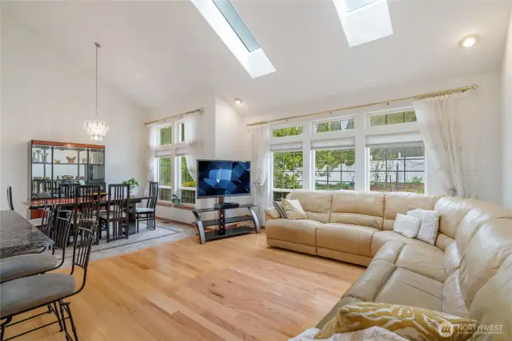 Great room with vaulted ceiling, skylighs and over-sized windows floods the room with morning light.