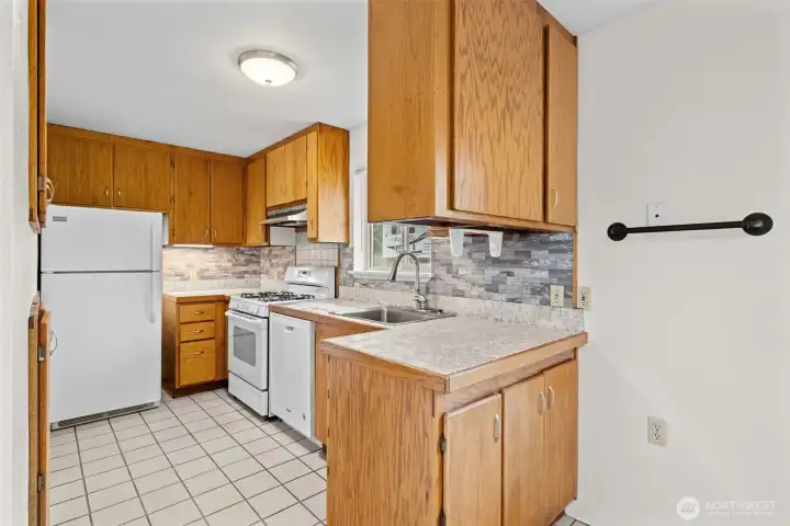 Functional, bright, and ready for your next meal.    This efficient kitchen offers ample cabinet storage, generous counter space, and a layout that makes everyday living easy.