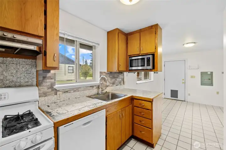 Classic wood cabinetry adds warmth and character while offering generous storage throughout the kitchen.