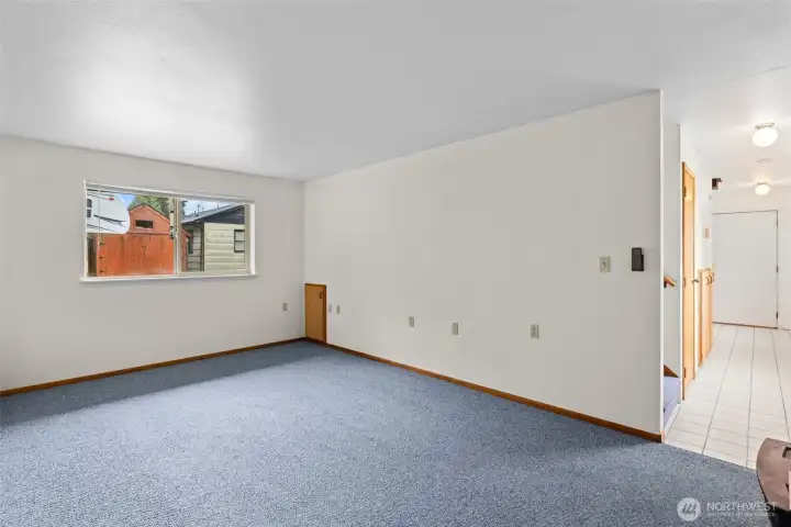 Generous main-floor living room featuring a second fireplace for year-round comfort and charm.