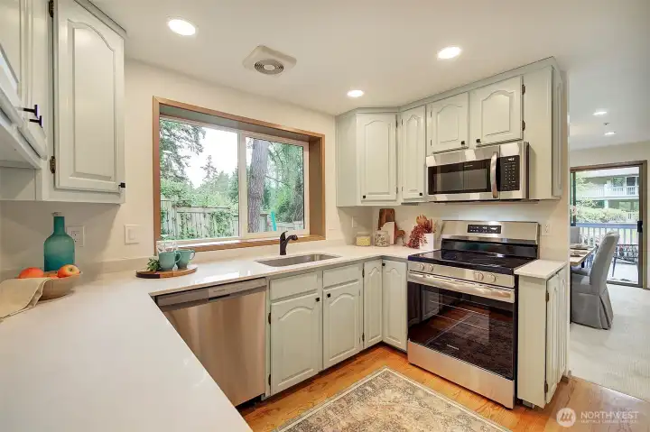 Bright and warm kitchen features quartz counters Bright and warm kitchen features quartz counters