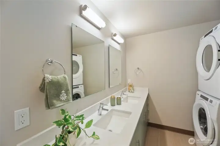 Double sinks in bathroom and an in unit washer/dryer