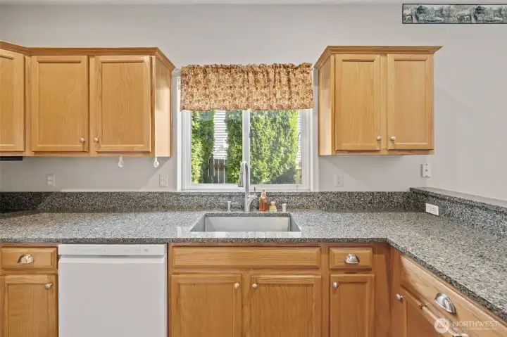 Bright window over the kitchen sink. Peninsula seating to the right so guests can watch the chef and stay out of the kitchen. Bright window over the kitchen sink. Peninsula seating to the right so guests can watch the chef and stay out of the kitchen.