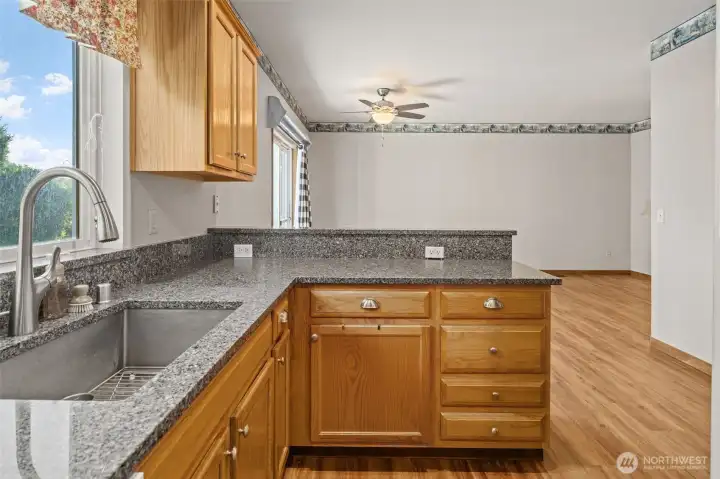 Kitchen overlooking the dining area with bar seating. Kitchen overlooking the dining area with bar seating.