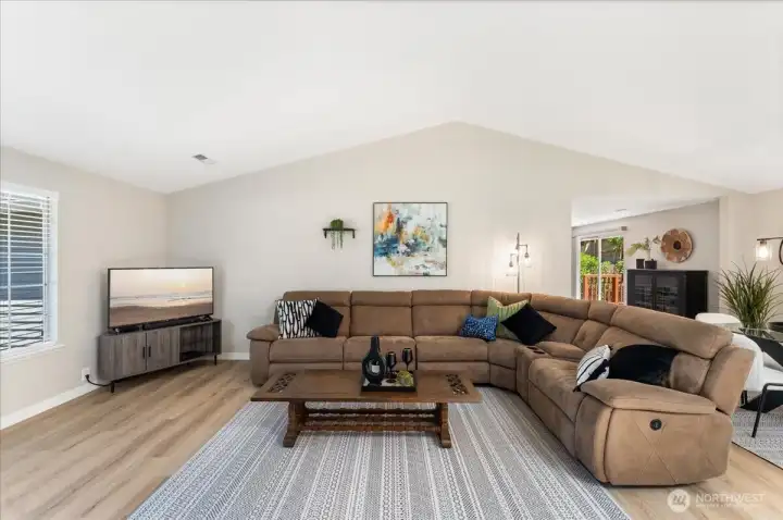 Spacious great room features vaulted ceilings and an airy, open feel. Updated luxury vinyl plank flooring flows throughout the main living areas. Spacious great room features vaulted ceilings and an airy, open feel. Updated luxury vinyl plank flooring flows throughout the main living areas.
