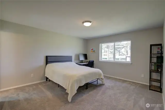 Primary bedroom looks over the golf course and has a walk-in closet and en suite bath.