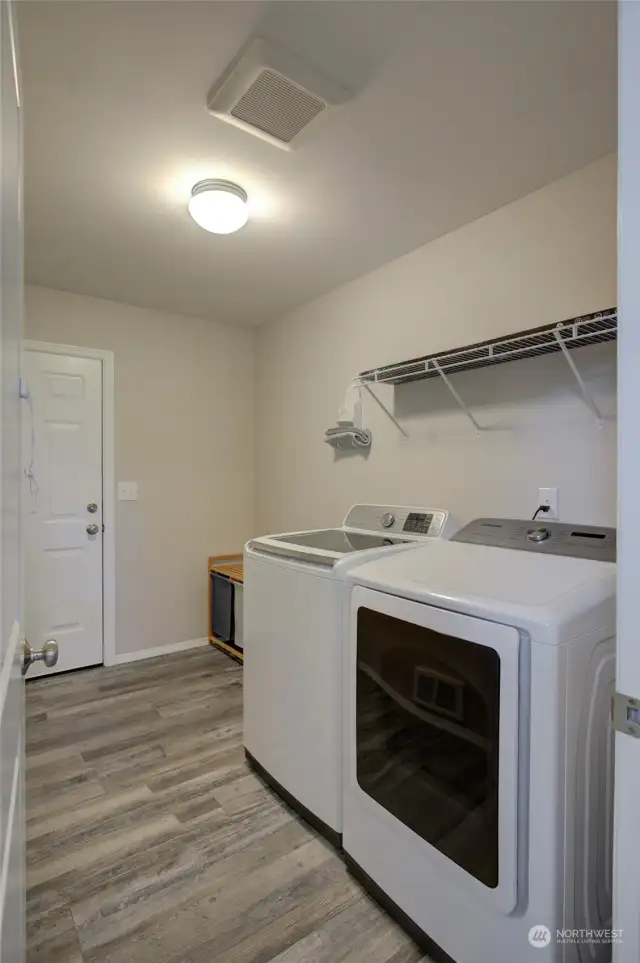Just outside the primary suite is the laundry room and garage access.